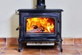 Cozy fireplace with roaring fire Royalty Free Stock Photo