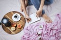 Cozy flatlay with white tanned woman in jeans making notes in her notebook