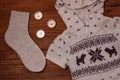 Cozy flatlay. Winter concept. Flat lay of knitted sweater, candles, needles and yarn on wooden background. Warm weekend