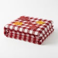 Cozy folded red and white gingham blanket with autumn leaf appliques Royalty Free Stock Photo