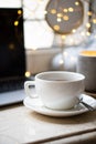 Cozy freelancer`s winter work place at home with cup of coffee