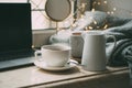 Cozy freelancer`s winter work place at home with cup of coffee