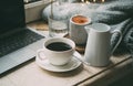 Cozy freelancer`s winter work place at home with cup of coffee