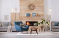 Cozy furnished apartment with niche in wooden wall and armchair Royalty Free Stock Photo