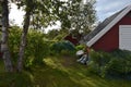 Cozy garden with red small cabin in Sweden Royalty Free Stock Photo