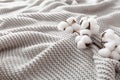 Cozy grey blanket with cotton flowers and copy space