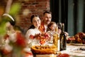 Close-up happy family, married couple celebrate Thanksgiving day, sitting at table with holiday traditional food, dishes Royalty Free Stock Photo