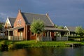 Cozy Dutch holiday home at lake in sunlight at evening