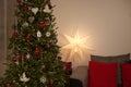 Cozy holiday living room with Christmas tree and decorations.