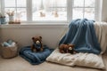 Cozy holidays at home. Cute little lying under blue knitted blanket with teddy bear on floor at window reading book. Winter season