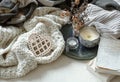 Cozy home composition with decorative wooden heart, candles and books