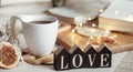 Cozy home composition with decorative word love on blurred background with bokeh Royalty Free Stock Photo