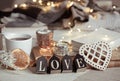 Cozy home composition with decorative word love on blurred background with bokeh Royalty Free Stock Photo