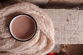 Cozy home details, winter season, hygge concept - cup of cocoa and woolen scarf on wooden, mindfullness and relax background Royalty Free Stock Photo