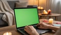 Cozy home evening with laptop and green screen for relaxation or work Royalty Free Stock Photo