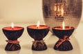 Cozy home interior decor, burning candles on the background of a metal vase Royalty Free Stock Photo