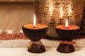 Cozy home interior decor, burning candles on a multi-colored rug on the background of a metal vase - Image Royalty Free Stock Photo