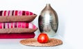 Cozy home interior decor: pillow, plaid, vase, plants in pots on a wicker stand on a white shelf in the room. The quarantine