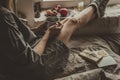 Cozy home. Woman with cup of hot drink sitting by the window. Royalty Free Stock Photo