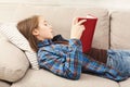 Cozy home. Young thoughtful girl with book Royalty Free Stock Photo