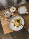 Cozy homemade morning and delicious breakfast - cottage cheese with caramelized apples and cappuccino on a wooden table