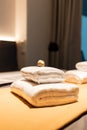 Cozy hotel bedroom with clean towels on the bed. Royalty Free Stock Photo