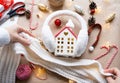 Cozy house in Christmas decor layout, warm knitted scarf, hat, winterization. Winter, snow - home insulation, protection from cold