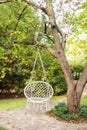 Cozy hygge place for weekend relax in garden. Cozy exterior backyard. Concept of rest outdoor. Hammock chair in boho style hanging Royalty Free Stock Photo