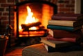 Cozy indoor scene with a stack of colorful books near a warm fireplace Royalty Free Stock Photo