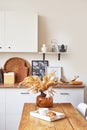Cozy interior of bright loft style kitchen. White kitchen set. Kitchen accessories. Shelves and dishes. Good morning. Stylish