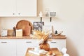 Cozy interior of bright loft style kitchen. White kitchen set. Kitchen accessories. Shelves and dishes. Good morning. Stylish