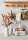 Cozy Interior Of The Living Room - Dried Flowers In A Vase, A Scandinavian Christmas Star, Books, Christmas Decorations, A Knitted
