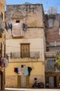 Cozy italian backyard with balcony, drying clothes and motorcycle. Traditional mediterranean architecture. Italian town landmark. Royalty Free Stock Photo