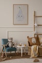 Cozy kids room interior with mock up poster frame, plush toys, brown pillow, blue armchair, round stool, ladder with star ornament