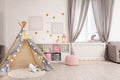 Cozy kids room interior with play tent