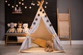 Cozy kids room interior with play tent and toys Royalty Free Stock Photo