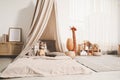 Cozy kids room with play tent, toys and comfortable floor bed. Montessori interior Royalty Free Stock Photo