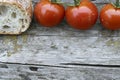A cozy kitchen features a rustic wooden table with an attractive arrangement of fresh vegetables, herbs, and bread Royalty Free Stock Photo