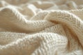 Cozy knitted texture of a cream-colored blanket