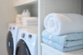 Cozy Laundry Room with Freshly Folded Towels and Modern Appliances Royalty Free Stock Photo