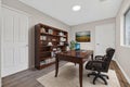 Cozy Library Setting For Work And Reading, Stylish Study Area Featuring Tall Shelves And Warm Lighting Royalty Free Stock Photo