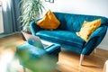 Cozy light living room with blue sofa and laptop, no people. Empty domestic room, cosy homeoffice space at home, modern Royalty Free Stock Photo