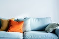 Cozy Living Room Corner With Blue Sofa and Colorful Cushions Against White Wall