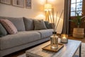 Interior of cozy living room with grey sofa and reed diffuser on coffee table Royalty Free Stock Photo