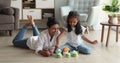 Indian woman play plastic toy set with little 6s daughter