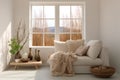 Cozy living room interior with beige sofa, knitted blanket and cushions. Royalty Free Stock Photo