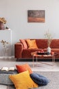 Cozy living room interior with corner sofa with pillows and painting on the wall Royalty Free Stock Photo
