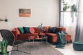 Cozy living room interior with corner sofa with pillows and painting on the wall Royalty Free Stock Photo
