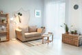 Cozy living room interior in eco style with comfortable furniture and green plants Royalty Free Stock Photo