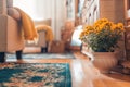 Cozy living room interior with yellow flowers yellow blanket and furniture. Blurred home closeup Royalty Free Stock Photo